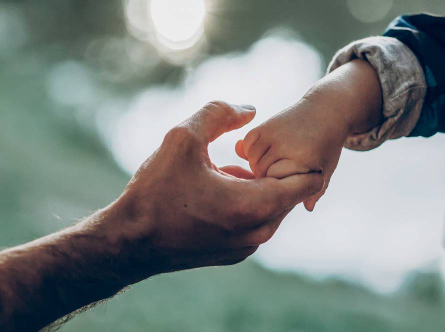 father and son holding hands outdoors 2023 11 27 05 35 02 utc