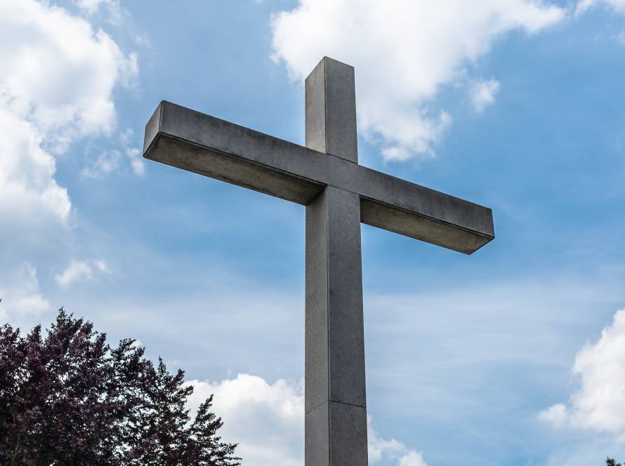a large concrete cross on a cemetery against a blu 2025 03 12 22 25 26 utc
