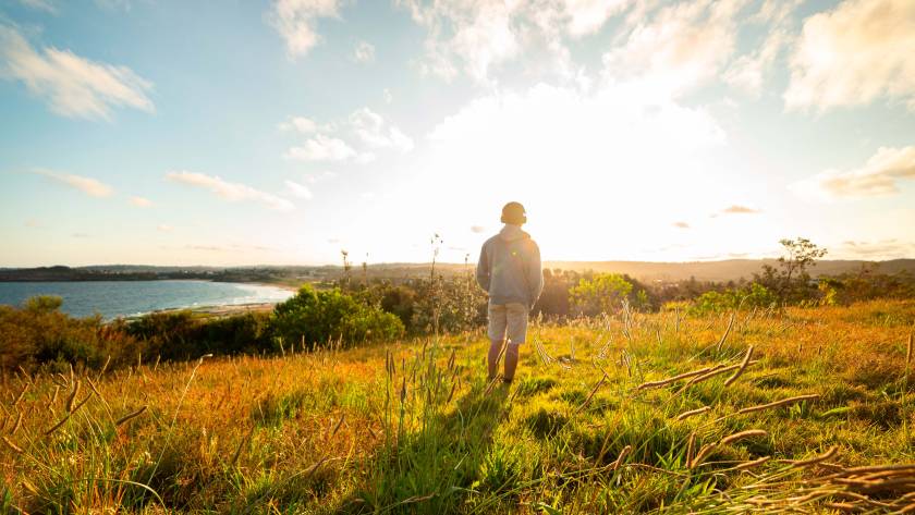 young man standing in a meadow listening music whi 2024 12 06 09 35 57 utc