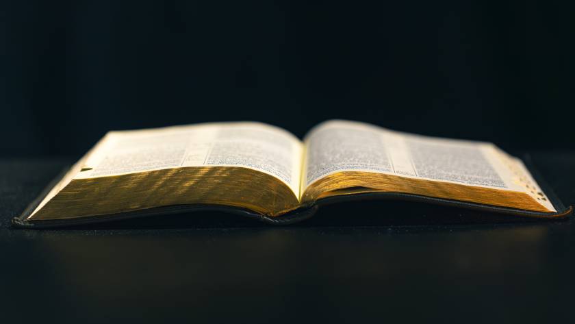 open bible on a black background religion concept 2025 03 16 04 36 28 utc
